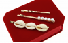 a set of clips with white pearls