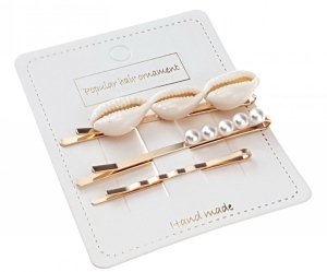 a set of clips with white pearls