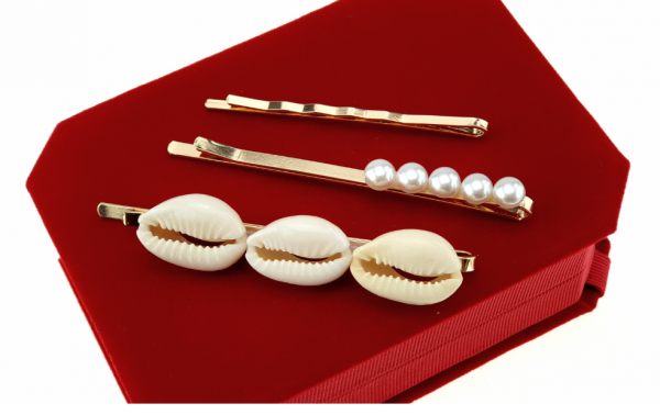 a set of clips with white pearls