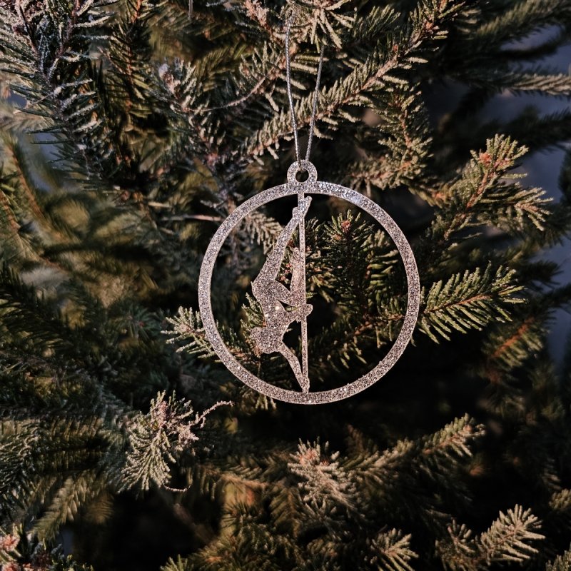 Silver Glitter Pole Dance Ornament Pose 5. Close-up on the Christmas tree background
