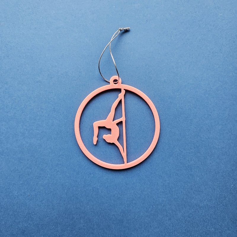 Pink Glow in the Dark Pole Dance Ornament (Pose C) on a blue background. Amira Perun Aerial Fitness